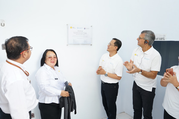 People looking at a note on a wall