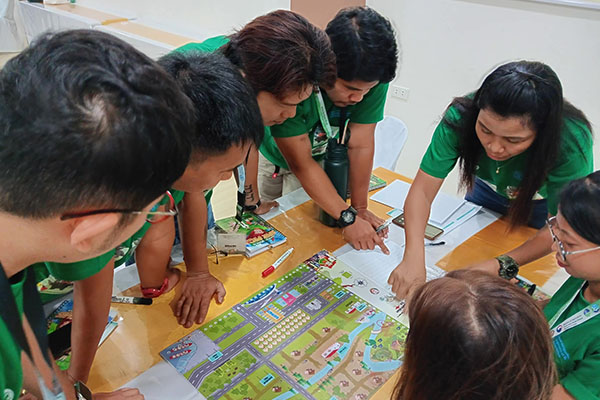 People pointing to an infographic on the table.