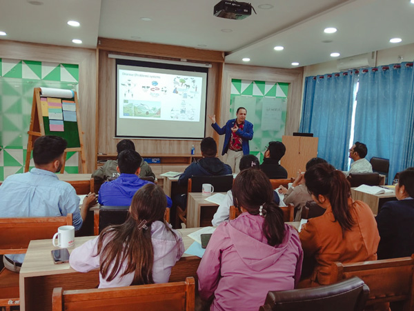Man lectures in front of a class