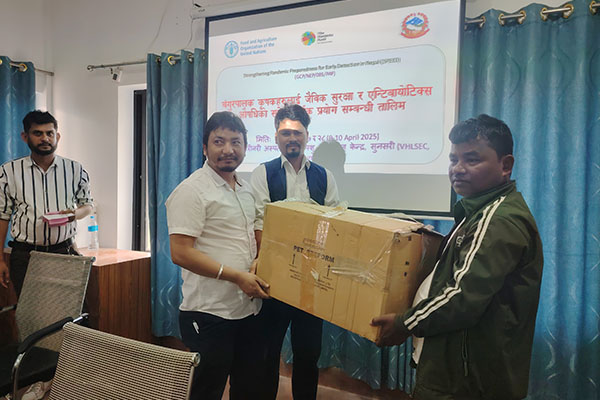 Two men carrying a box posing for a photo