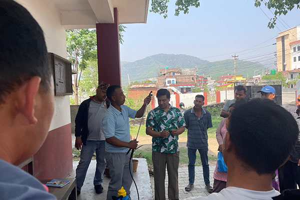 A man demonstrating a process to a group of people