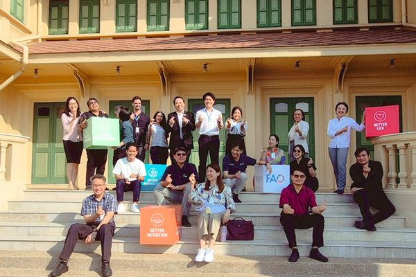 Group of people seated and standing on the stairs.