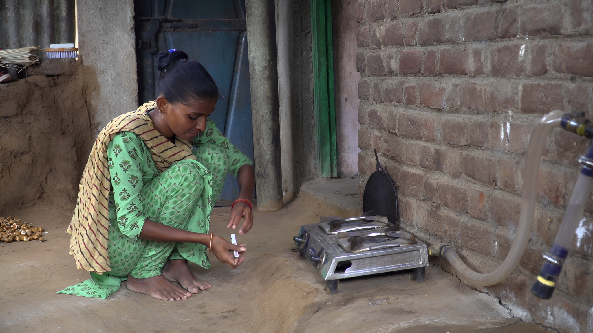 Indian woman in front of biogas cookstove