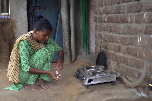 Indian woman in front of biogas cookstove